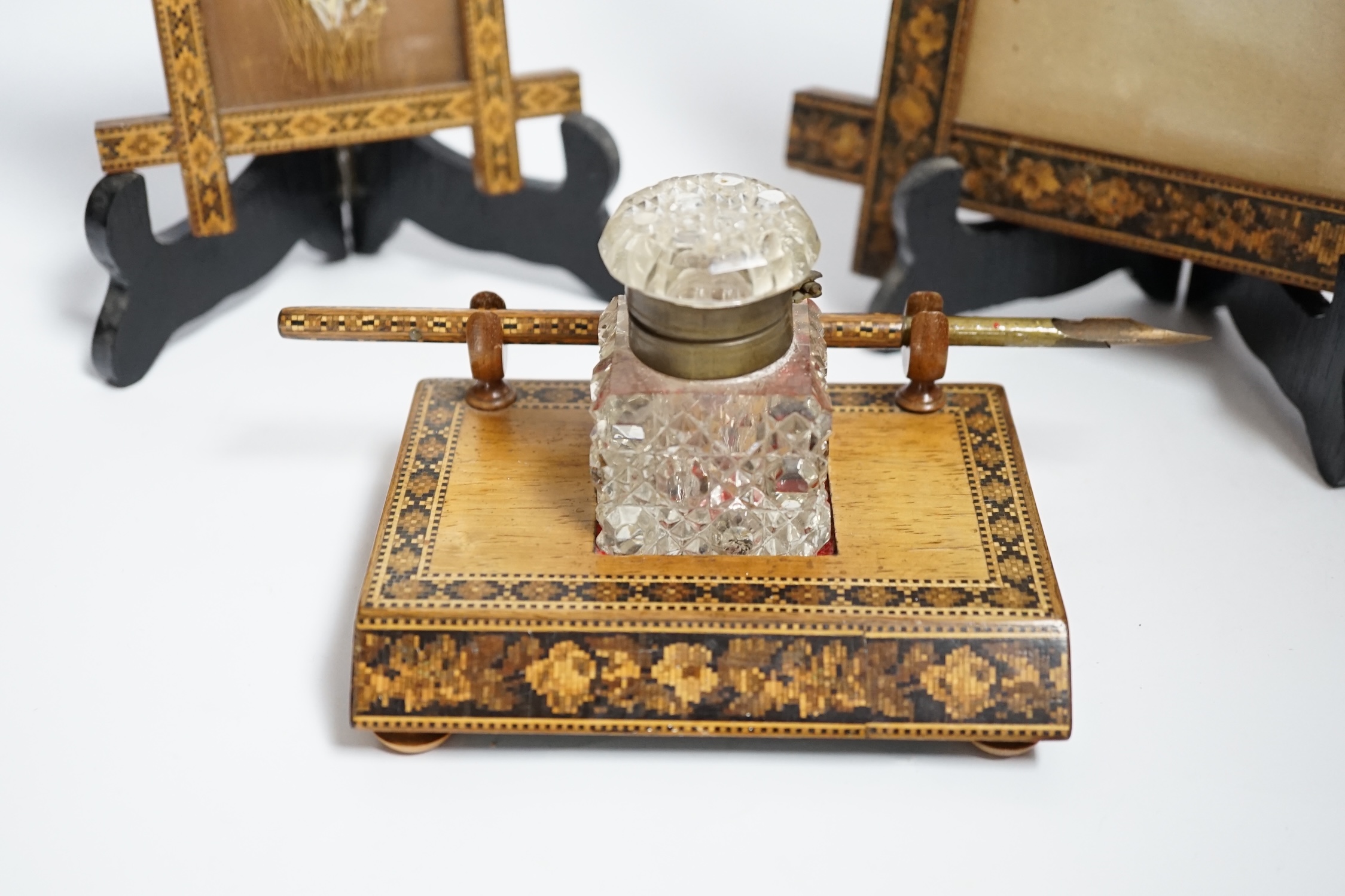 A Tunbridge ware inkstand with cut glass bottle and pen, together with two frames, largest 22.5cm high
